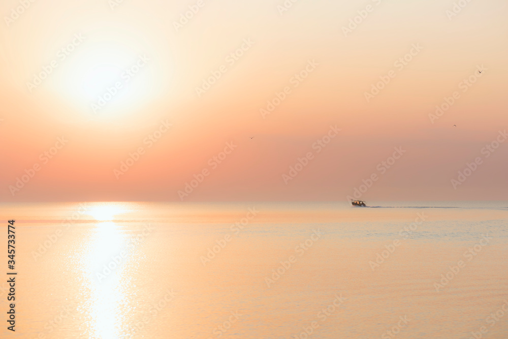 the boat sails on the sea at dawn