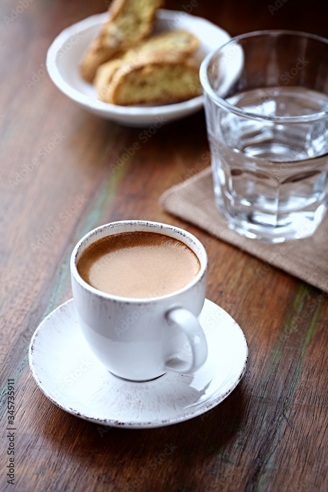 Cup of coffee with cantuccini (Italian cookies) on rustic wooden background. Cup of coffee with cantuccini (Italian cookies) on rustic wooden background.