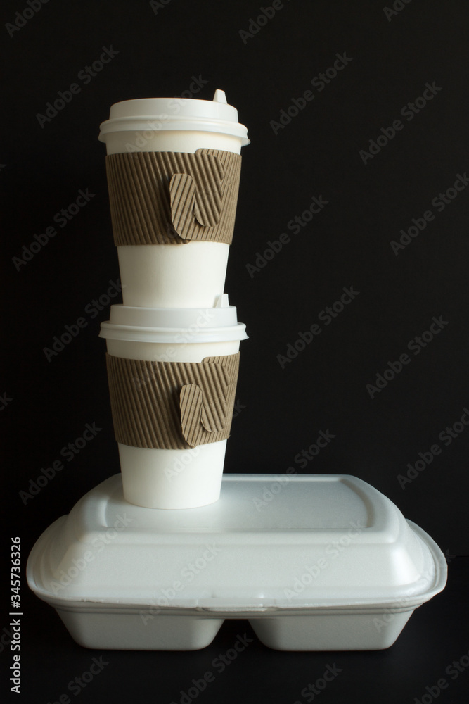 Coffee in disposable cups with a lid and a container with food to take away. Concept delivery. Coffee in disposable cups with a lid and a container with food to take away. Concept delivery.