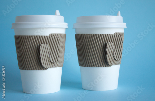 Wallpaper Mural Two white disposable coffee cups close up on a blue background and a copy space Torontodigital.ca