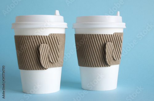 Wallpaper Mural Two white disposable coffee cups close up on a blue background and a copy space Torontodigital.ca