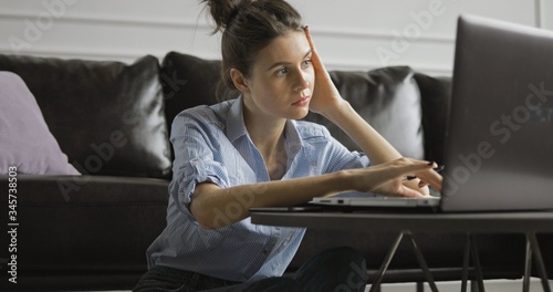 Young woman using digital tablet computer in home photo