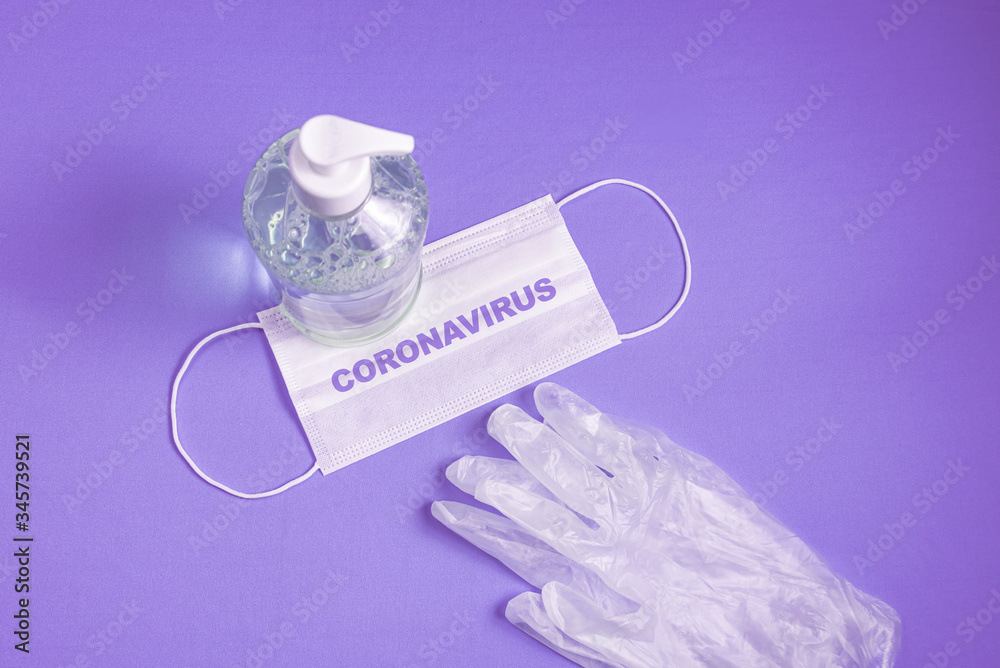 Container with alcohol gel, gloves and surgical mask on the light blue background Container with alcohol gel, gloves and surgical mask on the light blue background