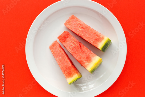 Fresh watermelon on red background from above