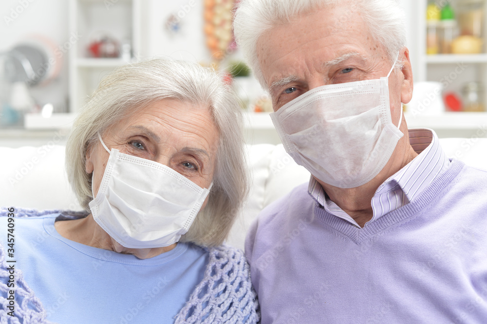 Close up portrait of sick elderly woman and man with facial masks