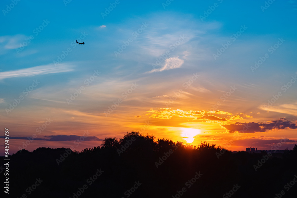 Airplane silhouette and beautiful sunset