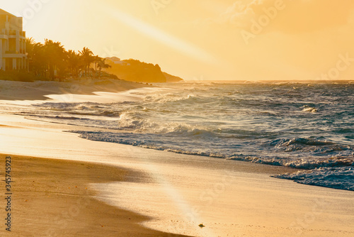 Fototapeta Naklejka Na Ścianę i Meble -  colorful tropical sunset on Anguilla island Caribbean sea with palm trees and ocean waves