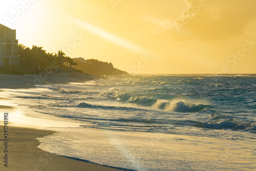 colorful tropical sunset on Anguilla island Caribbean sea with palm trees and ocean waves