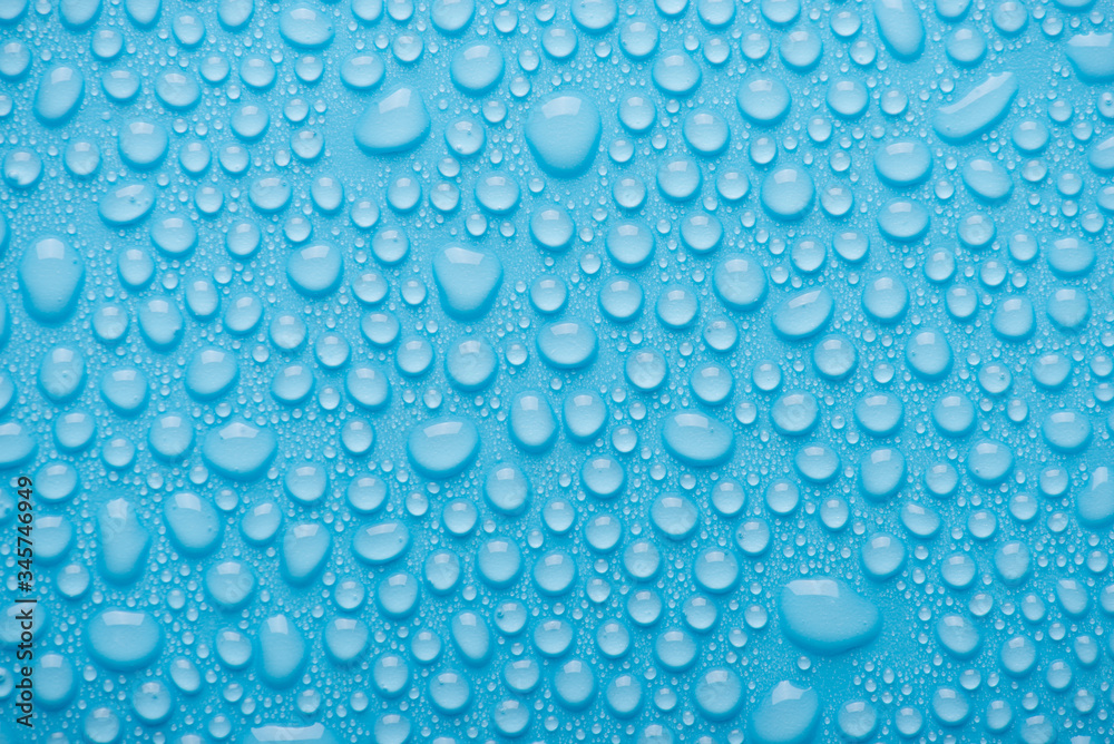 Top above overhead view close up photo of bright water drops on the blue background