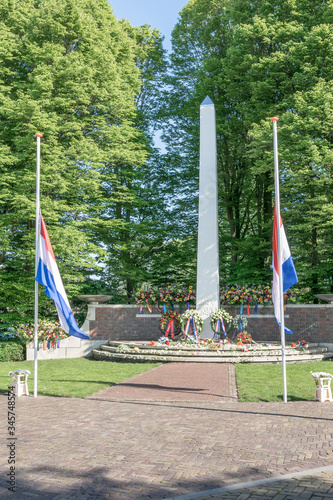 Remembrance day of the victims in the Second World War. Flowers and wreaths have been placed at the monument and the flags are at half-mast.