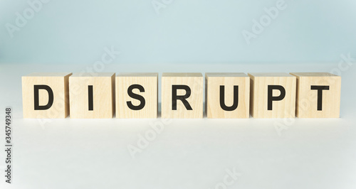 DISRUPT word on wooden cubes on a light background
