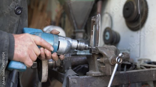 Wallpaper Mural Aged male hands drilling metal plate that clamps in a vice Torontodigital.ca