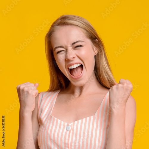 Crazy Sales. Young Girl Emotionally Shouting With Raised Fists, Celebrating Success