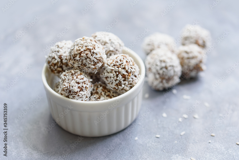 Healthy raw energy balls with cocoa, coconut, sesame, chia on white background. Healthy homemade paleo chocolate energy balls with rolled oats, nuts, dates. Raw vegan healthy dessert, selective focus Healthy raw energy balls with cocoa, coconut, sesame, chia on white background. Healthy homemade paleo chocolate energy balls with rolled oats, nuts, dates. Raw vegan healthy dessert, selective focus