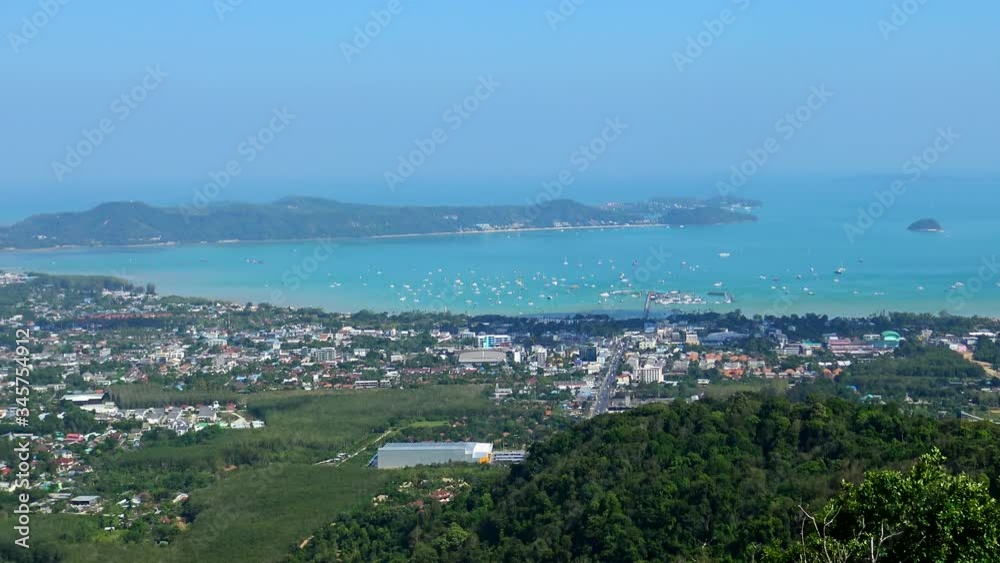 Panoramically view from the top of the hill over sea bay full of small boats and yachts at small touristic city in Phuket, Thailand. Panoramically view from the top of the hill over sea bay full of small boats and yachts at small touristic city in Phuket, Thailand.