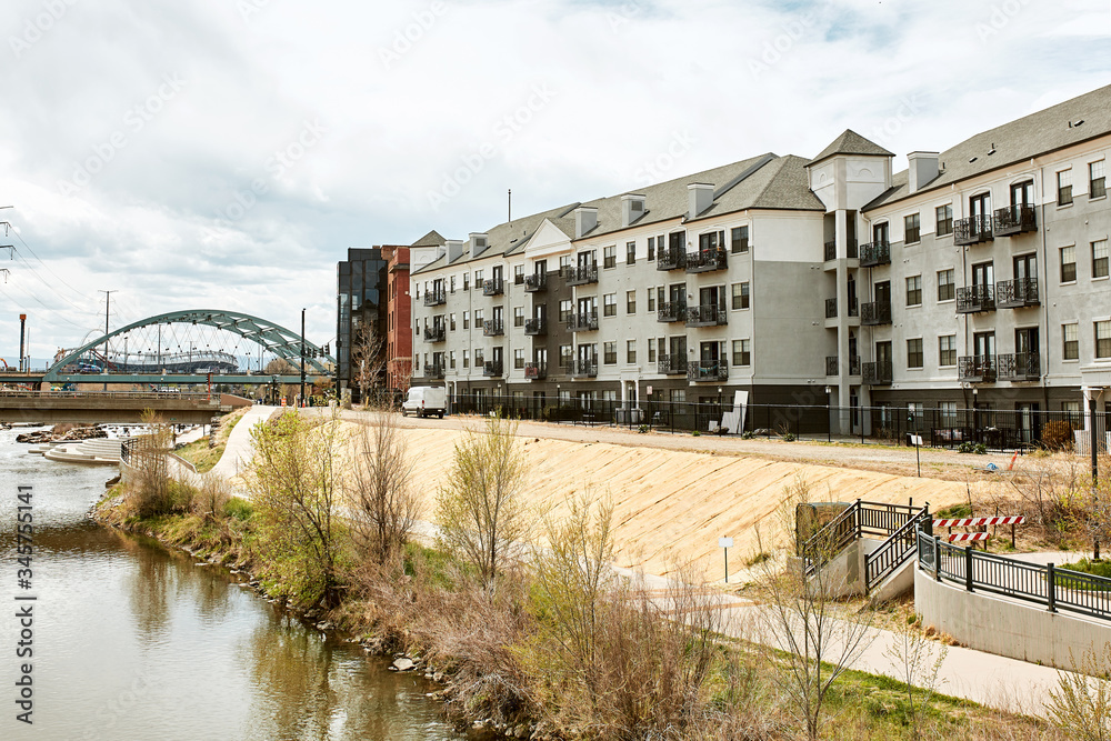 South Platte River in Commons Park with apartments and office buildings in the distance in lower Downtown Denver, Colorado South Platte River in Commons Park with apartments and office buildings in the distance in lower Downtown Denver, Colorado