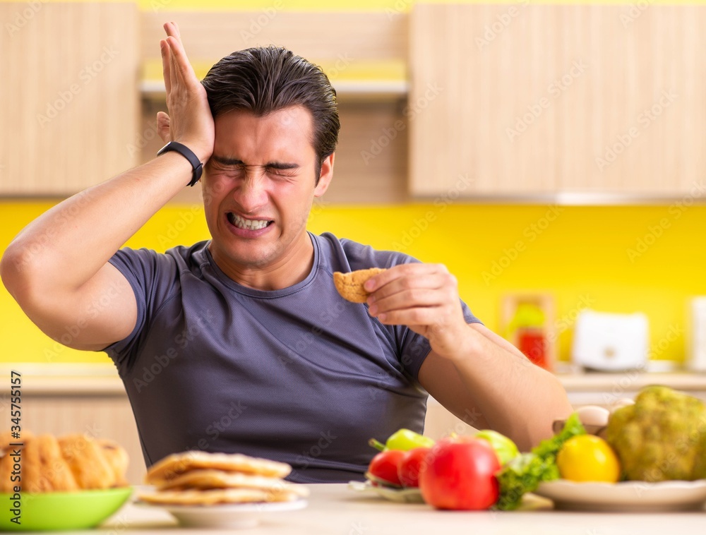 Man having hard choice between healthy and unhealthy food Man having hard choice between healthy and unhealthy food