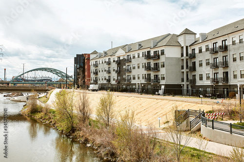 South Platte River in Commons Park with apartments and office buildings in the distance in lower Downtown Denver, Colorado
