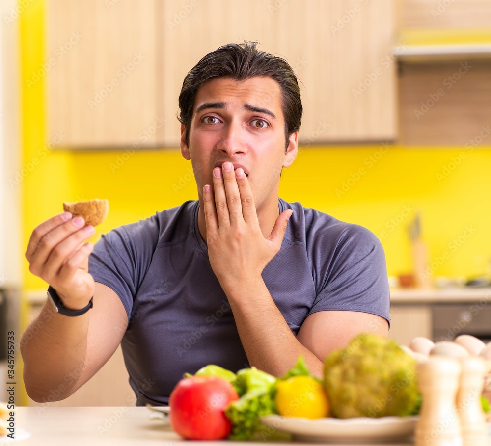 Man having hard choice between healthy and unhealthy food Man having hard choice between healthy and unhealthy food