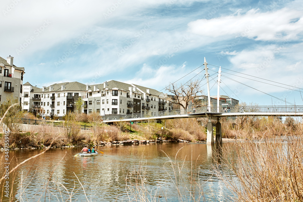 Fototapeta premium South Platte River Bridge, surrounded by modern apartments and office buildings in Commons Park . Denver, Colorado