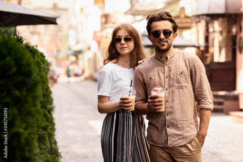 young beautiful couple have a fun and walking on city streets and drinking coffee © jul14ka