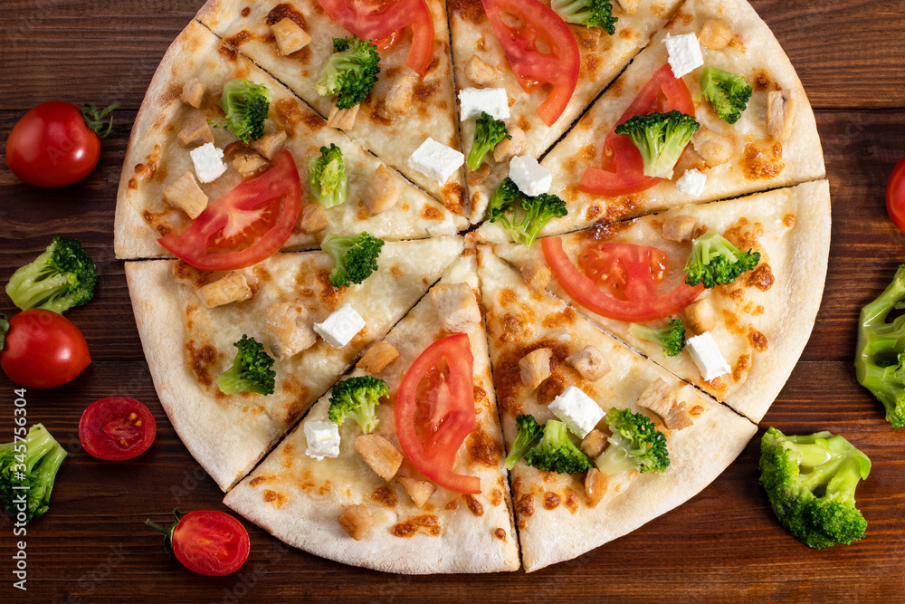 Pizza with chicken, broccoli and feta cheese on wooden background. Top view Pizza with chicken, broccoli and feta cheese on wooden background. Top view