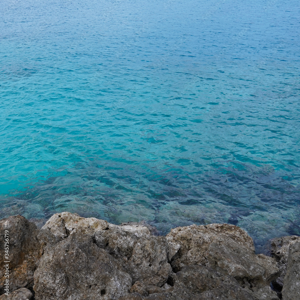 Obraz premium Fantastic rocky shore of the ocean, oceanic beach, stone coast, natural sea background incredible color of water. Paradise island of Okinawa. Miyakojima. Japan