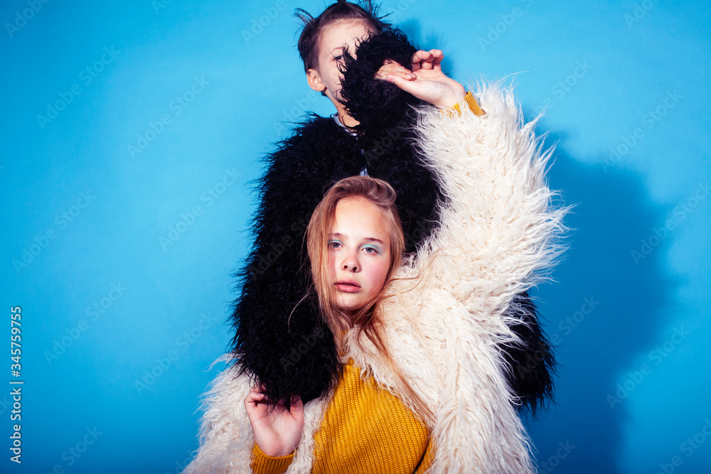 young and pretty fashion models boy and teenage girl posing cheerful on blue background, lifestyle people concept young and pretty fashion models boy and teenage girl posing cheerful on blue background, lifestyle people concept