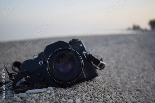 Vintage camera on the shore of a beach