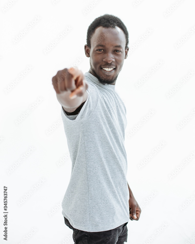 young man in a white t-shirt points at you. young man in a white t-shirt points at you.