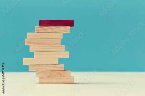 Personal identity. Teamwork and teambuilding. Not like everyone. Pile of wooden planks with one red block, copy space