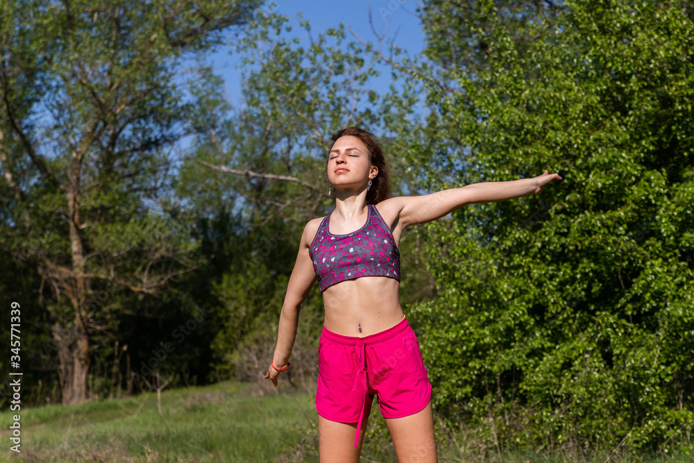 Girl in sport clothes doing sport exercises on fresh air Girl in sport clothes doing sport exercises on fresh air