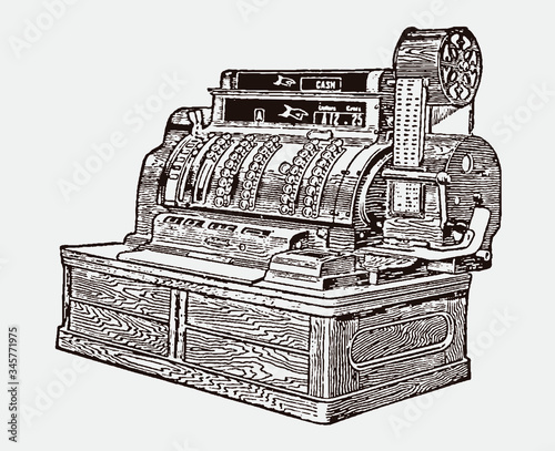 Antique wooden cash register from the early 20th century in three-quarter front view