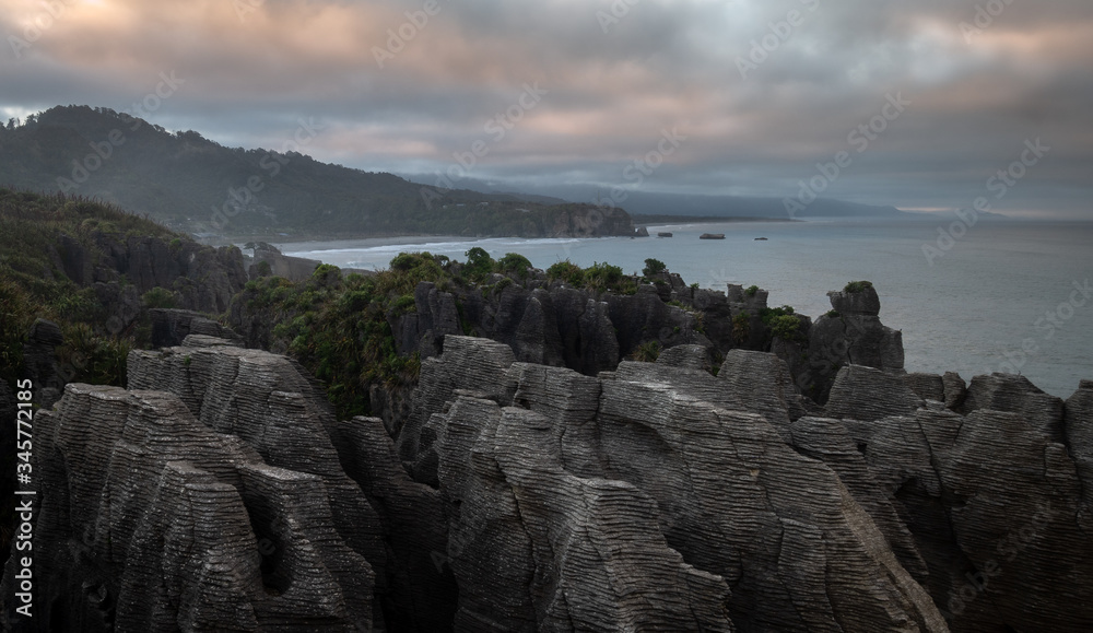 Unusual rock formations on ocean´s coast shot during sunrise, Picture made at Punakaiki Pancake Rocks, West Coast, New Zealand