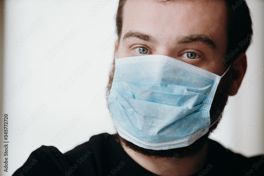 Portrait of man wearing a protective medical face mask to prevent infection of coronavirus. Portrait of man wearing a protective medical face mask to prevent infection of coronavirus.