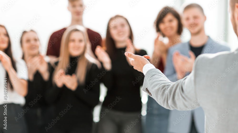 blurry image of a group of different people standing in a confe blurry image of a group of different people standing in a confe