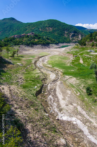 drought and temperature rise catastrophe, dry river and town without water.