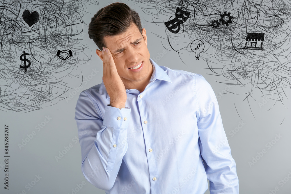 Stressed man with mess in his head on grey background Stressed man with mess in his head on grey background