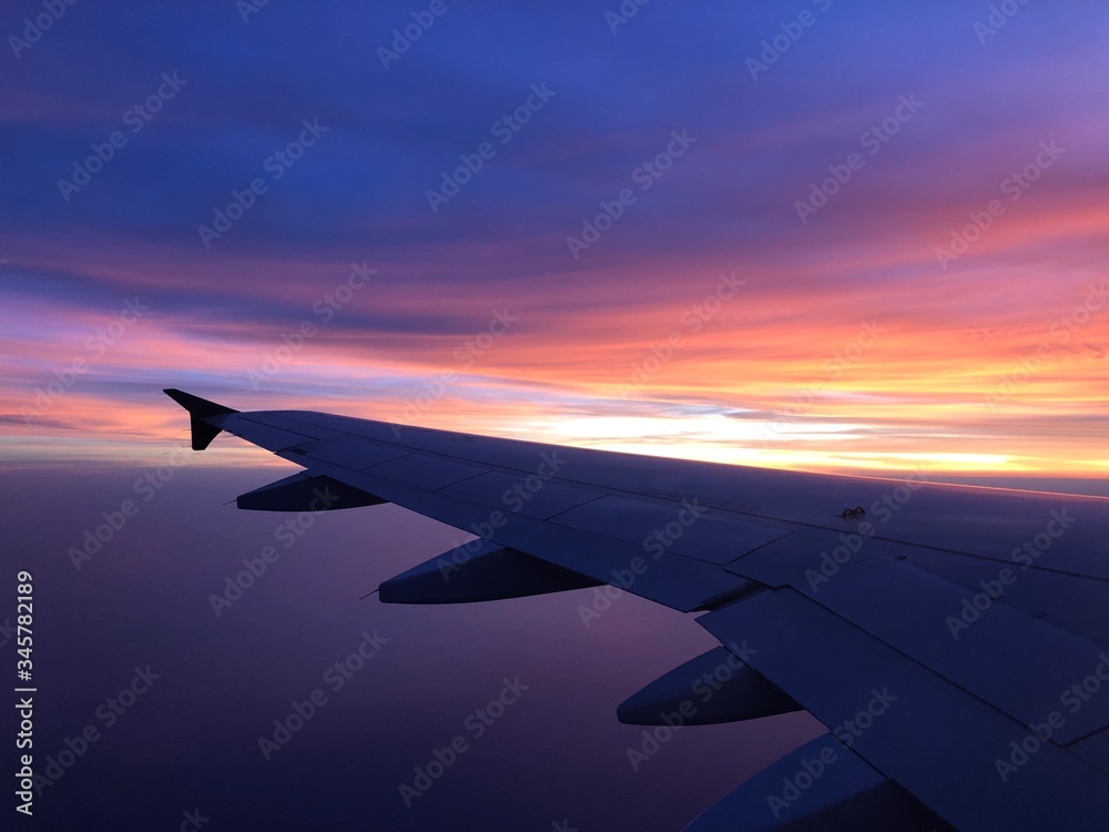 Fototapeta premium Photo of the sunset from plane.