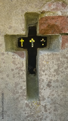 crosses in a crypt line up in this interesting photo.