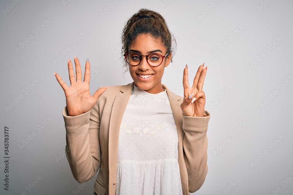 Beautiful african american businesswoman wearing jacket and glasses over white background showing and pointing up with fingers number eight while smiling confident and happy. Beautiful african american businesswoman wearing jacket and glasses over white background showing and pointing up with fingers number eight while smiling confident and happy.
