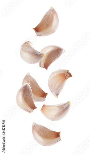 Set of falling garlic cloves on white background