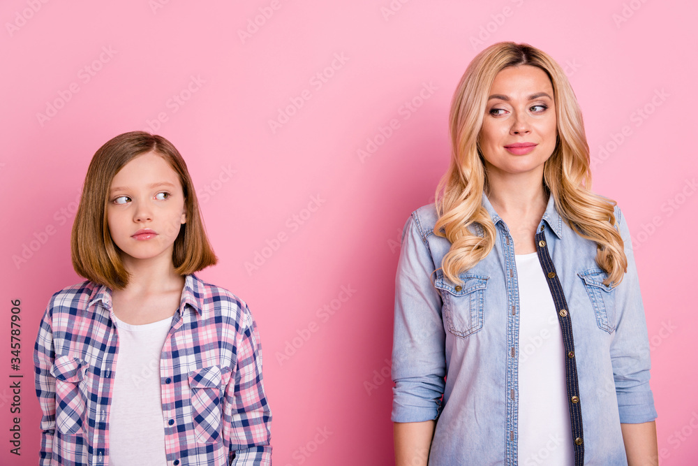 Portrait of minded woman girl mother daughter look each other wear casual style clothes isolated over pastel color background Portrait of minded woman girl mother daughter look each other wear casual style clothes isolated over pastel color background