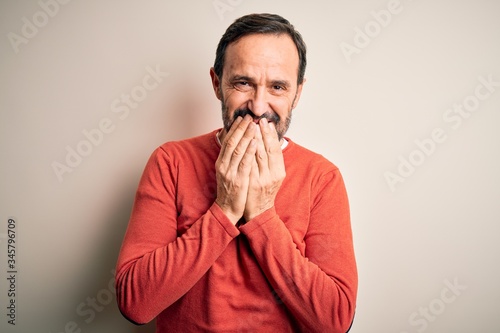 Принти на полотні Middle age hoary man wearing casual orange sweater standing over isolated white
