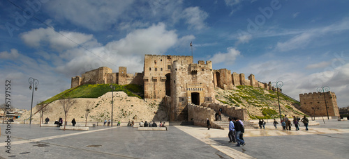 Aleppo Castle in panoramic view with blurred people photo