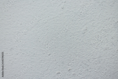 rough white painted wall with bumps texture background