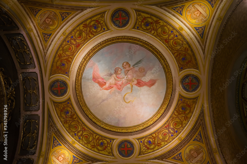 Cordoba, Argentina - January, 2020: Interior of Cathedral of Cordoba church ( Iglesia de Nuestra Senora de la Asuncion) . Painted ceiling fresco view of two angles in the sky.