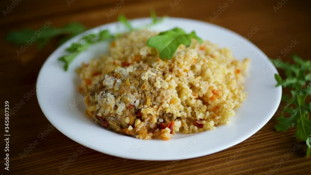 boiled bulgur groats with vegetables and meatballs in a plate boiled bulgur groats with vegetables and meatballs in a plate