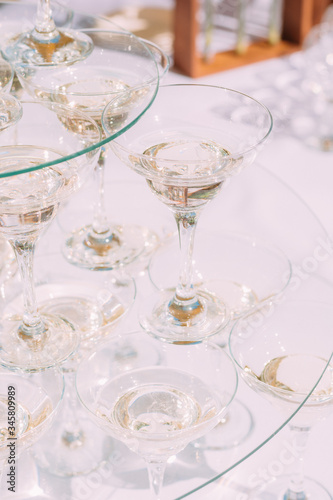 A pyramid of glasses of champagne. White sparkling wine in glasses.