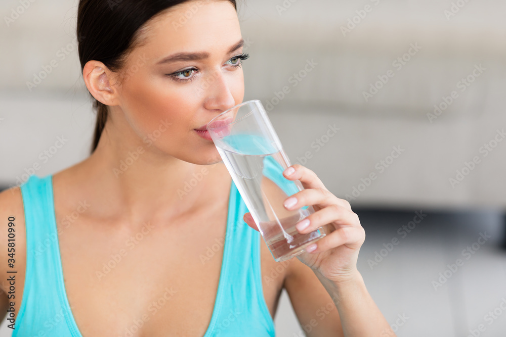 Sporty Girl Drinking Glass Of Water Sitting At Home Sporty Girl Drinking Glass Of Water Sitting At Home
